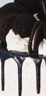 Close-up of Oreo cake with creamy frosting and chocolate cookies.