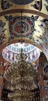 Intricate church ceiling with gold tones and chandelier.