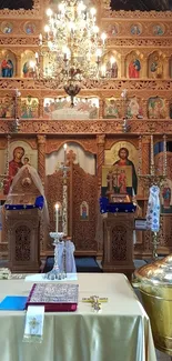 Ornate church interior featuring wooden icons and a gold chandelier.