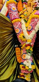 Colorful floral garland elegantly arranged on a traditional idol.