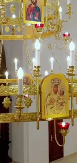 Golden chandelier with religious icons and candles.