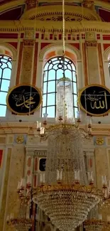 Intricate mosque interior with chandelier and colorful windows.