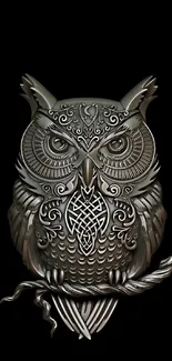 Intricate metallic owl design on a black background.