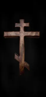 Orthodox wooden cross on a dark background.