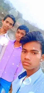 Group of friends taking a selfie in a natural outdoor setting.