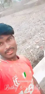 Two friends taking a selfie outdoors with a natural backdrop.