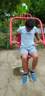 Person using outdoor gym equipment in a park.