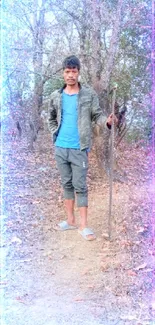 Man standing on forest path in outdoor scene.