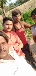 Group of friends enjoying a sunny day outdoors in a field.