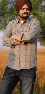 Man standing in a field with trees.