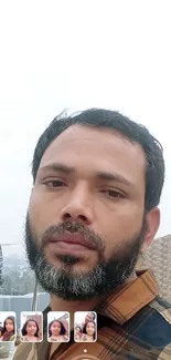 Portrait of a bearded man outdoors with a cloudy sky background