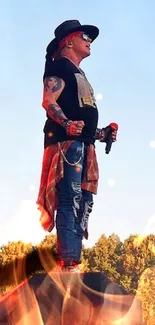 Rock musician performing on an outdoor stage at sunset.