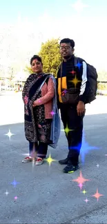 Couple standing outdoors with blue sky backdrop.