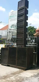 Powerful outdoor speaker setup in cityscape.