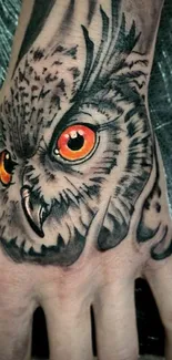 Detailed owl tattoo design on a hand.