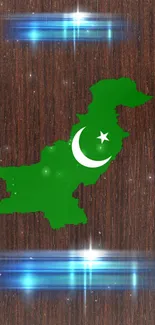 Green Pakistan map with crescent on wooden texture background.