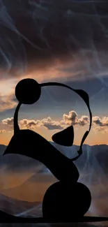 Panda silhouette in sunset over misty mountains wallpaper.