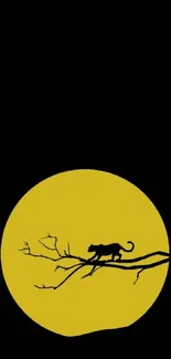 Panther silhouette on a branch against a yellow moon.