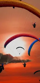 Paragliders with colorful canopies flying in a stunning sunset sky.