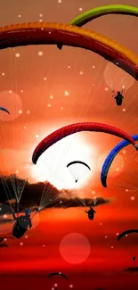 Colorful paragliders against a crimson sunset sky.