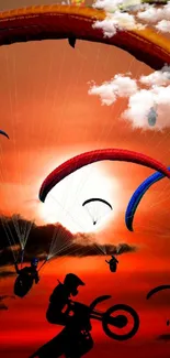 Paragliding against a vibrant orange sunset.