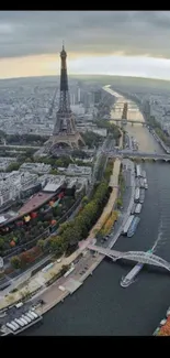 Aerial view of Paris with Eiffel Tower and Seine River on a cloudy day.