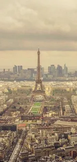 Aerial view of Eiffel Tower with Paris skyline in background.