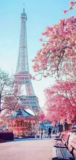 Eiffel Tower with pink cherry blossoms in Paris during spring.