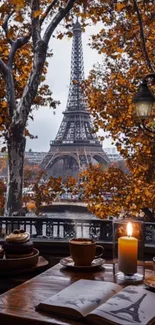 Autumn view of Eiffel Tower through a cozy window with coffee and candle.