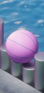 Pastel ball resting on cylinders by blue water.
