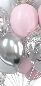 Pastel pink and silver balloons in a festive arrangement.