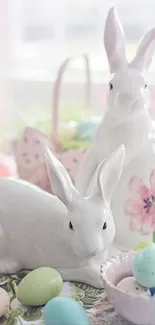 Ceramic rabbits with pastel Easter eggs on a decorative table.