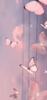 Pastel pink butterflies against a soft sky background, creating a serene mobile wallpaper.