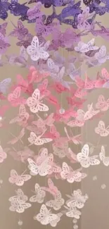 Cascading pastel butterflies in purple and pink hues create a dreamy wallpaper design.