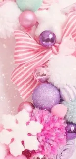 Pastel wreath with pink bow and ornaments.