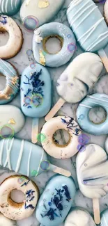 Pastel blue donuts and popsicles on marble background.