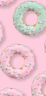 Pastel pink and mint donut pattern wallpaper.