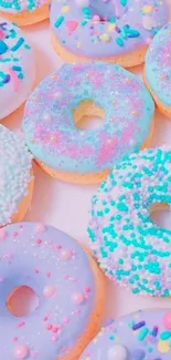 Pastel donuts wallpaper with colorful sprinkles.