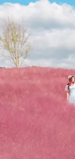 Woman in pastel pink field under blue sky.