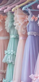 Pastel dresses hanging on a rack.