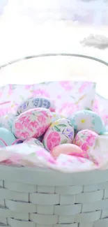 Pastel Easter basket with decorated eggs nestled inside.