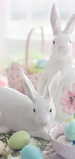 Ceramic bunnies with pastel Easter eggs on a floral tablecloth.