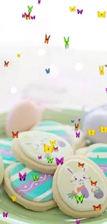 Pastel Easter cookies and eggs on a green plate.