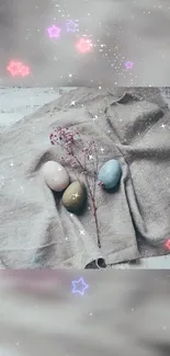 Pastel Easter eggs with glowing stars on rustic fabric