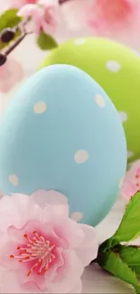 Pastel blue and green Easter eggs with pink blossoms.