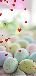 Pastel Easter eggs with floating red hearts on a festive mobile wallpaper.