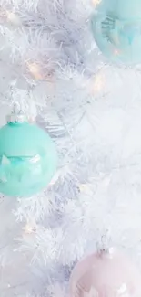 Pastel ornaments hanging on white tree.