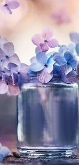 Pastel hydrangeas in a glass jar with a dreamy bokeh background.