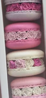 Pastel macarons decorated with roses in a box.