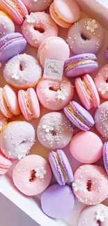 Pastel macarons and donuts in assorted colors create a sweet-themed wallpaper.